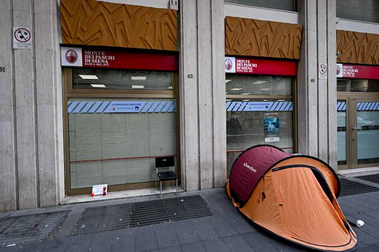 La tenda di un clochard posta al di fuori dell'entrata di una banca