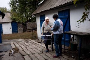 Una donna anziana e un'operatrice sanitaria